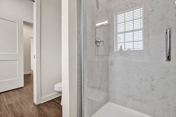 En-suite bathroom with stand-alone shower with tile surround.